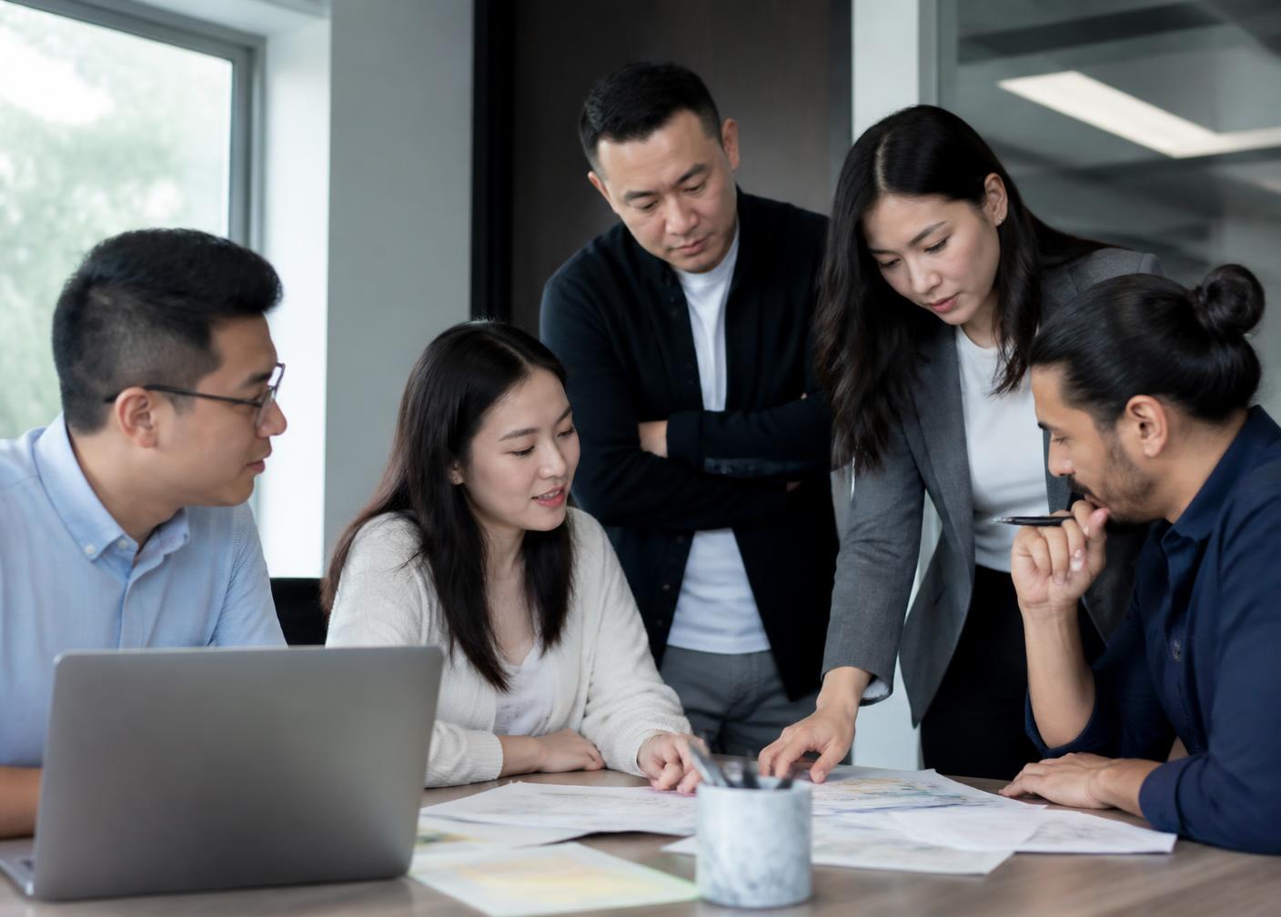 Asian professionals collaborating on strategy